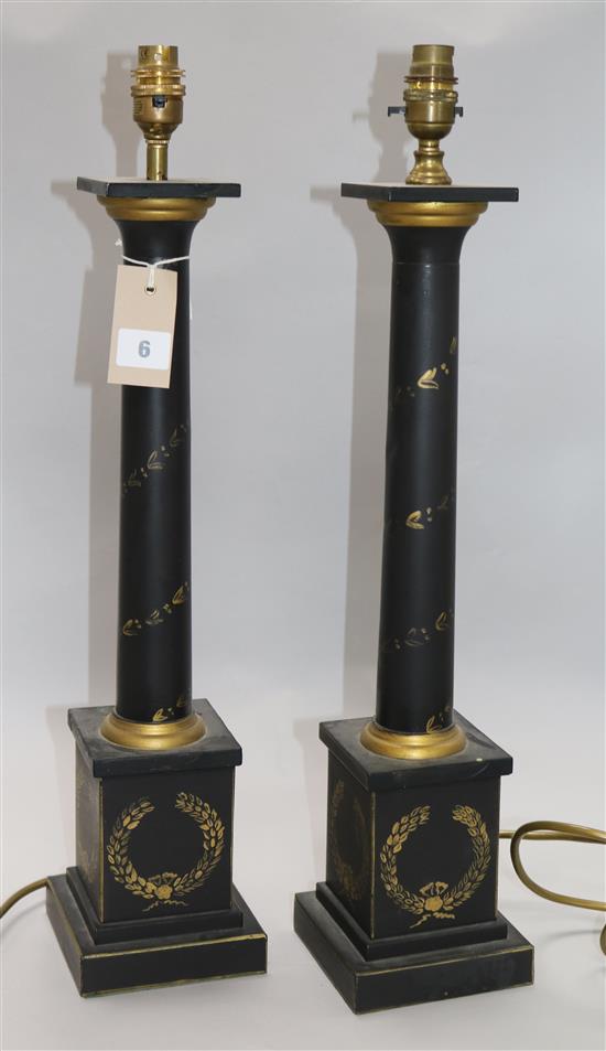 A pair of parcel guilt black painted table lamps Height: 57cm